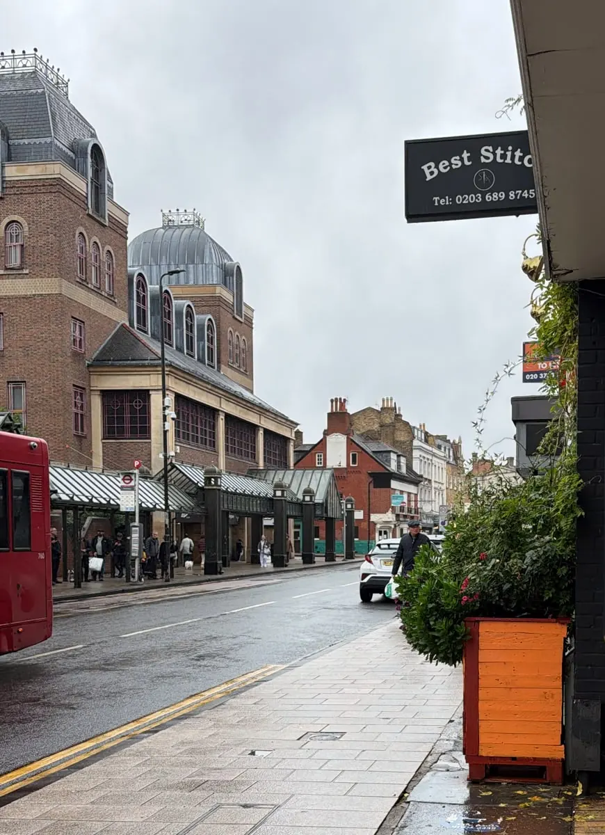 Widmore Road on a rainy day, with the hanging Best Stitch sign above the pavement