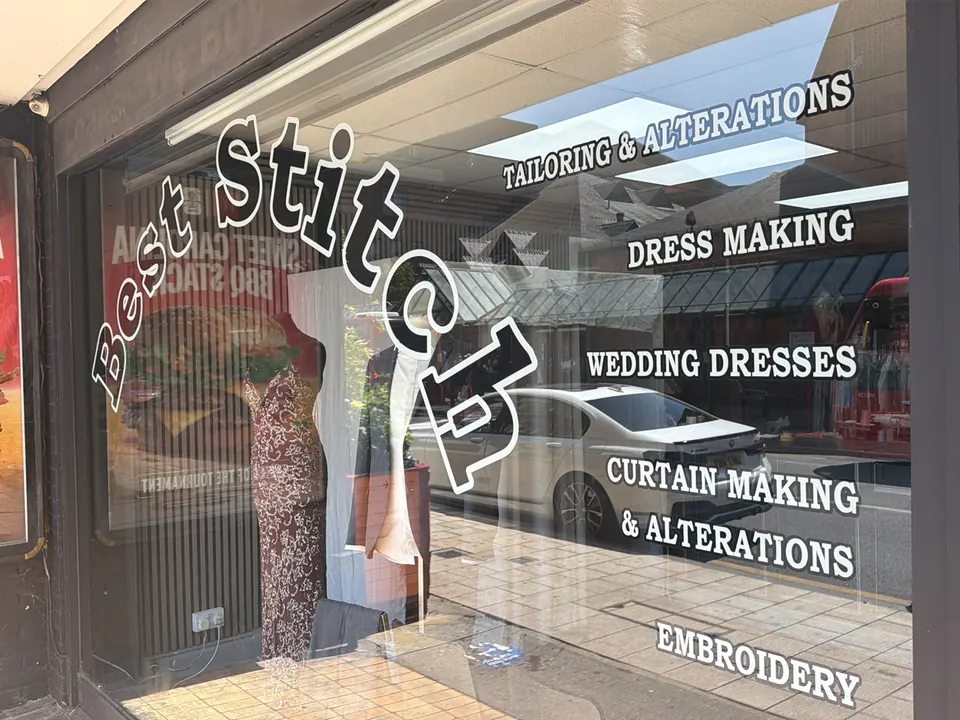 The Best Stitch shop window, lettered with tailoring and alterations, dress making, wedding dresses, curtain making and embroidery